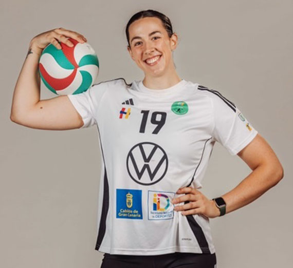 Woman in red Gonzaga t-shirt among fans cheering at basketball court